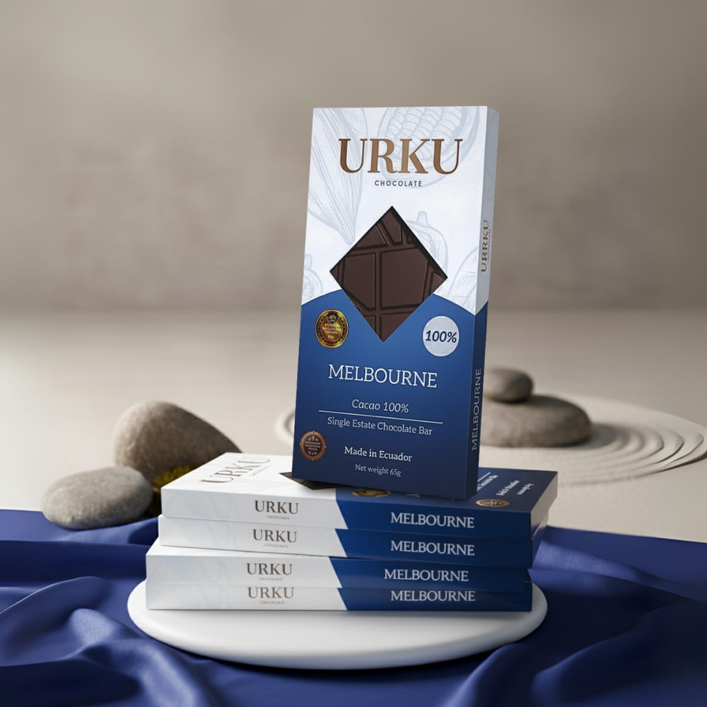 100% URKU chocolate bar, award winning luxury chocoalte on a blue fabric with a neutral background