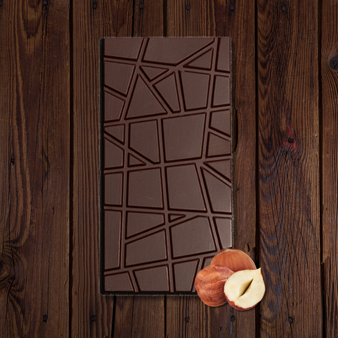 URKU Melbourne Hazelnut luxury dark chocolate broken into pieces, highlighting the rich cacao and hazelnut crunch.