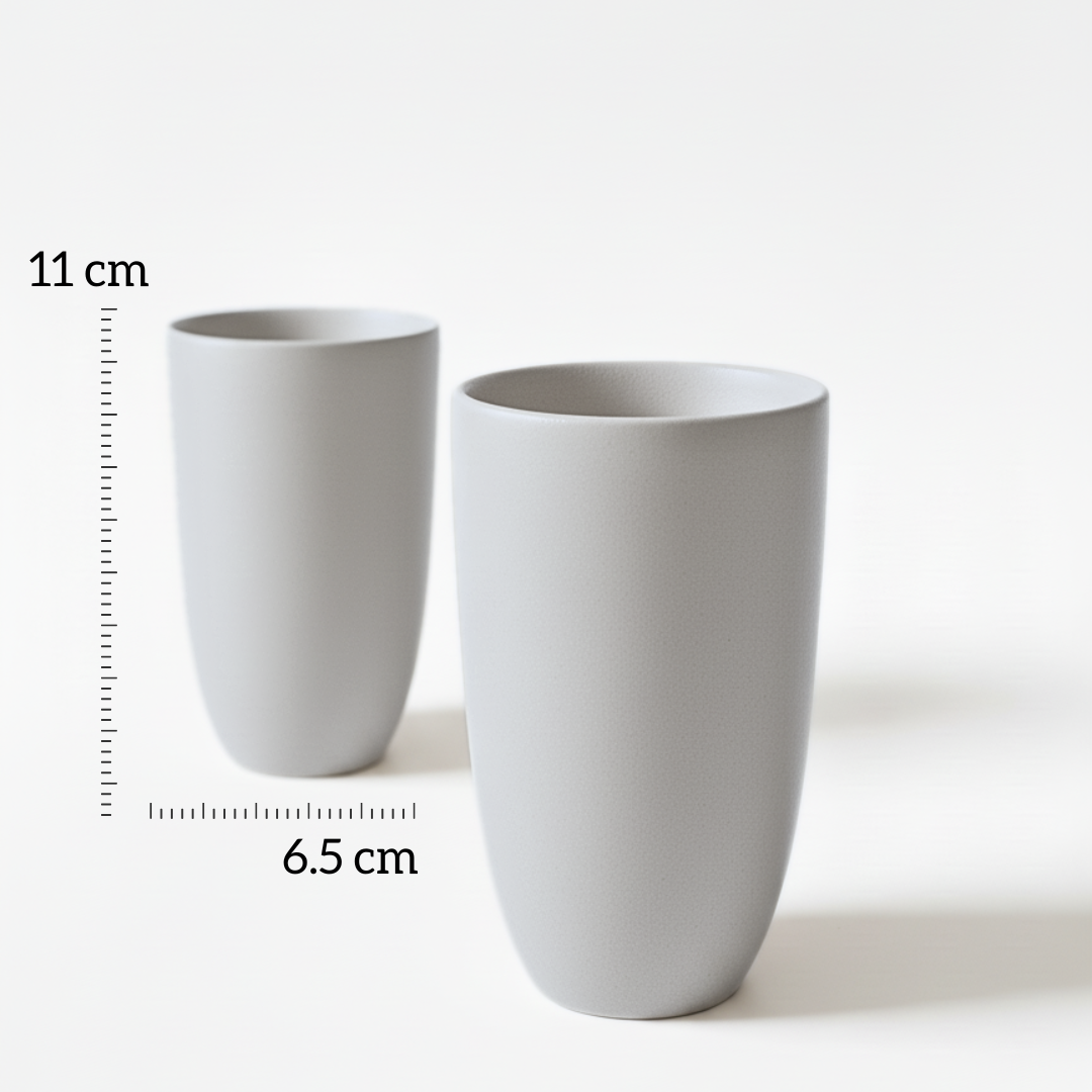 Grey Beige Full Moon cupsv- Two grey ceramic cups with measurements on a white background