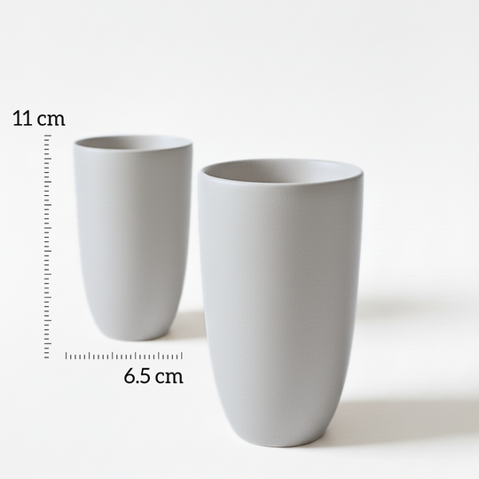 Grey Beige Full Moon cupsv- Two grey ceramic cups with measurements on a white background